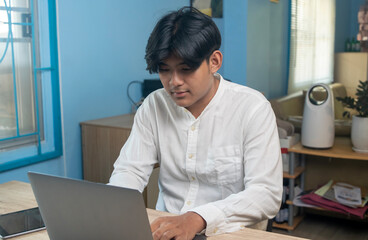 Teenager boy using laptop computer for online education studying, distance learning at home