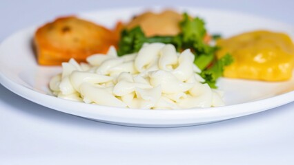 Delicious Creamy Pasta Dish with Savory Sides and Fresh Herbs