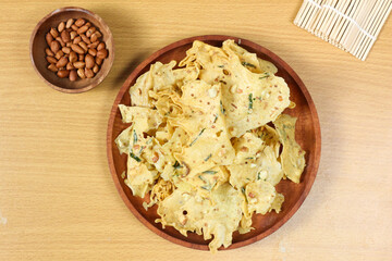Delicious Rempeyek, Crispy Peanut Crackers on Wooden Plate