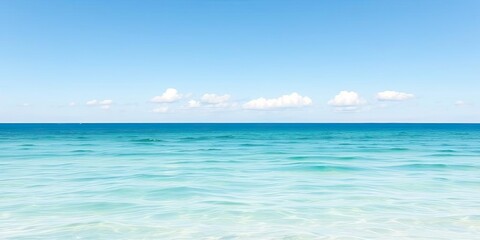 Obraz premium Serene Ocean Landscape Calm Turquoise Water Under a Blue Sky with Clouds
