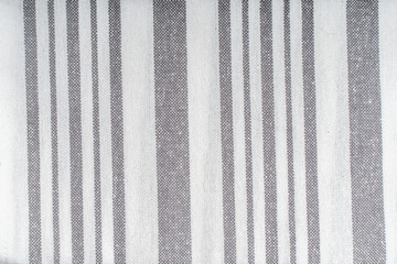 Background with white gray stripe fabric texture. A strict and laconic background with stripes of different widths.