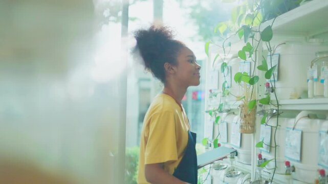 Eco friendly shop owner using  notebook to check bio organic products stock in container dispenser at plastic free grocery store. Sustainable small local business SME startup go green market.