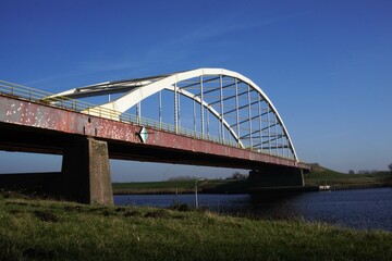 Obraz premium Bridge in the Netherlands, Europe. The Slaak Bridge that connects Brabant and Zeeland. A steel construction that connects roads and makes land accessible for transport via the motorway over the inland
