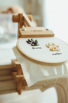 Close-up of an embroidery hoop with animal paw prints