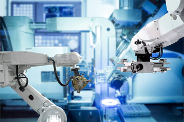 Modern technology with industrial automation gripping robot and welding robot are working with metalwork via assembly line on smart manufacturing concept and left copy space, industry 4.0