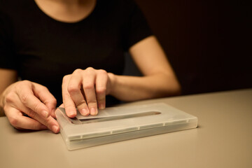 Hands Placing an Object on a Table in a Softly Dimly Lit Setting That Evokes Calmness and Serenity