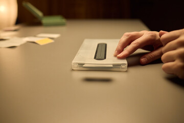Hands Placing an Object on a Table in a Softly Dimly Lit Setting That Evokes Calmness and Serenity
