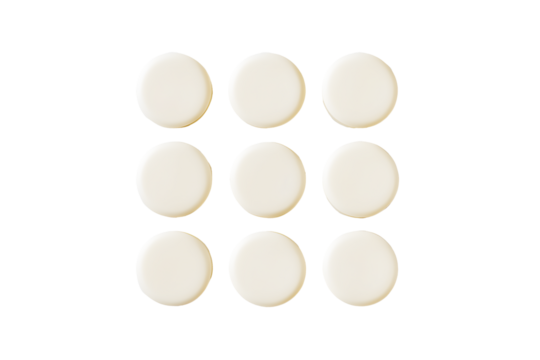 Round milk tablets arranged neatly isolated on cut out PNG or transparent background. Vitamins and calcium nourish body. Emphasizing their smooth texture and creamy color. Health and dietary product.