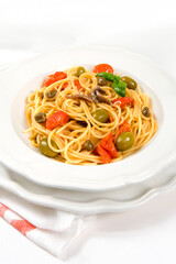 Spaghetti alla puttanesca or spaghetti whit tomatoes, olives and anchovies typical of Sicilia and Trapani area