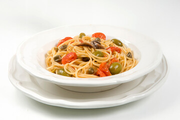 Spaghetti alla puttanesca or spaghetti whit tomatoes, olives and anchovies typical of Sicilia and Trapani area