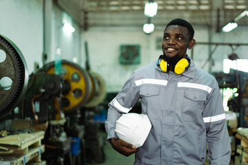 African black male engineer portrait in factory.