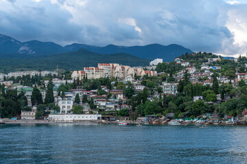 Fototapeta premium Gurzuf. View from the sea to Yalta city at sunset. Crimea