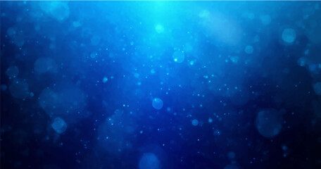 backdrop of abstract bokeh particles in blue light © Ashraful