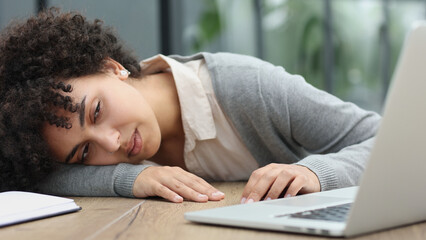 woman in the office sleeping at the workplace at the computer