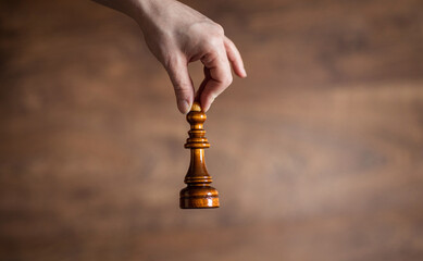 game of chess. Chess pieces in a woman's hand.