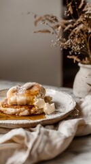 fluffy pancakes topped with melting butter and drizzled with maple syrup