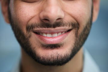 Obraz premium young beautiful man with brown eyes looks at the camera.