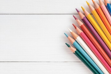 Obraz premium A soft watercolor painting of a bundle of colored pencils on a wooden artist desk