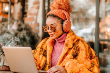 A student reading peer-reviewed academic journals on a laptop for dissertation references