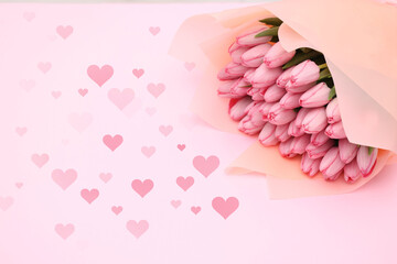 Bouquet of beautiful tulips and hearts on pink background