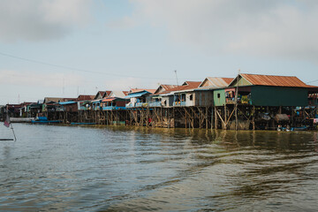 Cambodia, Tonle Sap Lake – Traditional Floating Village of Kampong Phluk with Stilt Houses and Fishing Boats in a Rural Southeast Asian Landscape