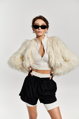 Chic young woman in stylish attire and fur jacket exudes confidence in trendy fashion