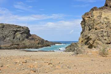 Bay near the pirate caves of Ajuy in Fuerteventura. Turquoise blue Atlantic Ocean with roaring...