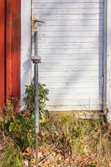 Old digging bar by a wooden cottage door