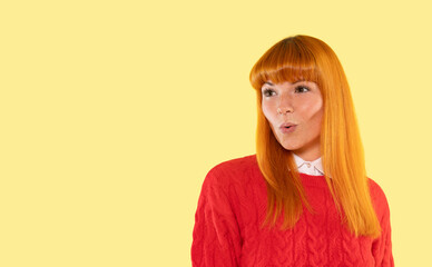 Brightly colored portrait of a woman with orange hair displaying an expressive gesture