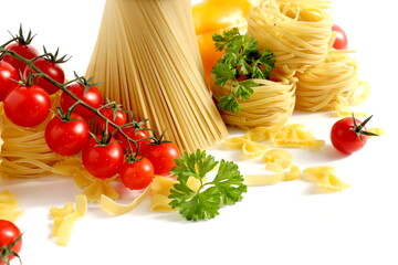 On a white background there are pasta in the form of a basket, vegetables and tied spaghetti...