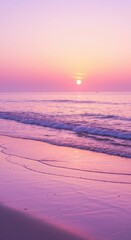 Serene pink sunset over ocean waves on tranquil beach shoreline