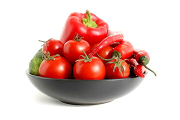 There is a ceramic plate with fresh vegetables on a white background.