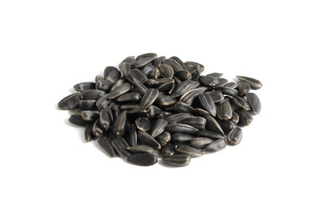 A bunch of sunflower seeds lie on a white background.