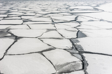 Broken, frozen sections of ice on Lake Ontario along the shoreline in the city of Toronto, Canada.