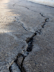 Crack in the road is shown in the image