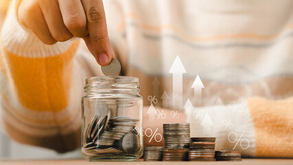 Concepts of saving money and financial planning. Man hand holding piggy bank on wood table, income, return, retirement, compensation fund, investment, dividend tax, stock market