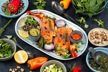 Raw salmon steak and ingredients for cooking.