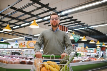 Handsome man shopping in a supermarket