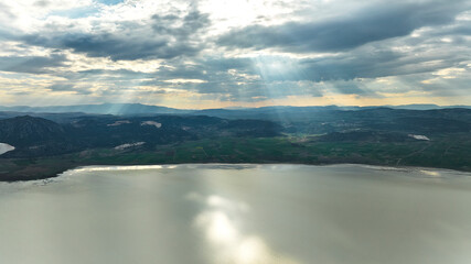 Aerial drone landscape panorama view of Lake Karatas (aka Karataş Gölü) and beautiful sunset clouds with reflections on the water, Burdur, Turkey
