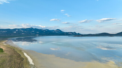 Aerial drone panorama landscape of Lake Yarisli (aka Yarışlı G&ouml;l&uuml;) and  mirror like reflection of clouds at sunset, Yesilova, Burdur, Turkey. 