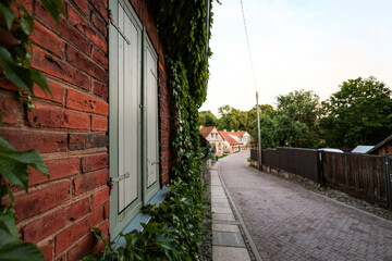 Beautiful small countryside city view with red brick house window on the left side.