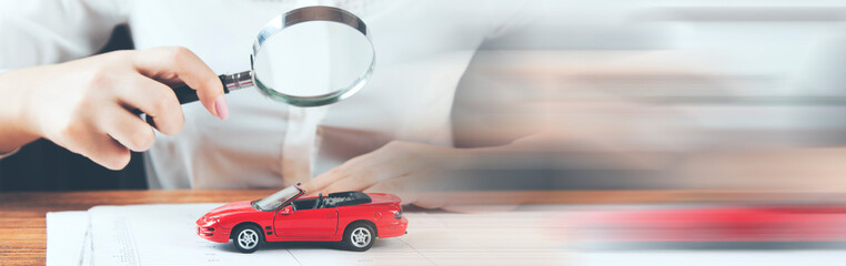 woman hand car model with magnifer