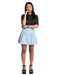 Fototapeta premium A young woman with long, straight black hair, wearing a black-striped shirt and a light blue skirt, stands confidently.