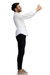 man on a white background. in full height. shows thumbs up sign, in profile