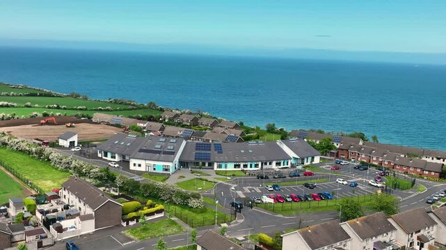 Slow motion Aerial view of Corran Integrated Primary School and Nursery Larne Irish Sea County Antrim Northern Ireland