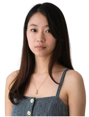 young woman with long, straight black hair, wearing a gray ribbed dress with a gold necklace.