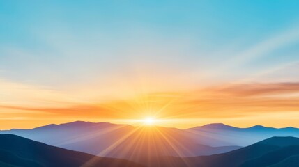 Obraz premium Panoramic view of a vibrant sunset over a mountain range. Soft, golden, orange, and blue hues paint the sky. The sun is prominent in the center