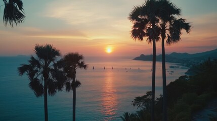 sunset scene in Phuket, with the sun descending over the Andaman Sea, creating vibrant colors across the sky. Palm trees frame the view, adding to the tropical serenity of the moment.