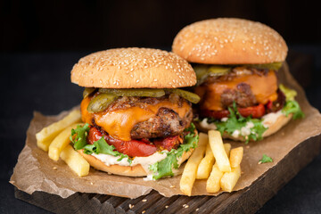 Classic cheeseburger with pickles, mayo sauce, lettucce and tomatoes served with french fries,...