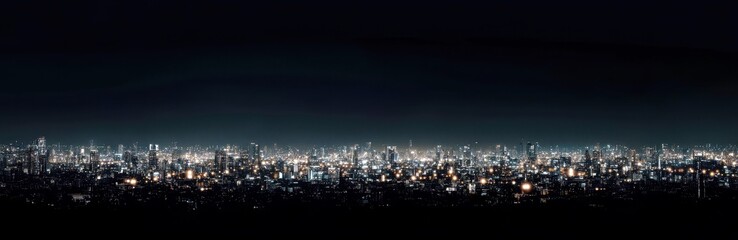 Obraz premium Panoramic View of City Skyline Illuminated at Night with Bright Lights and Dark Sky in the Background, Capturing Urban Life in Vibrant Atmosphere